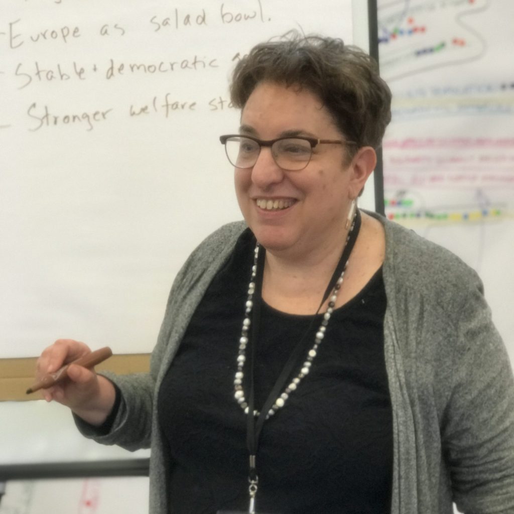 A woman writing on a flip board.