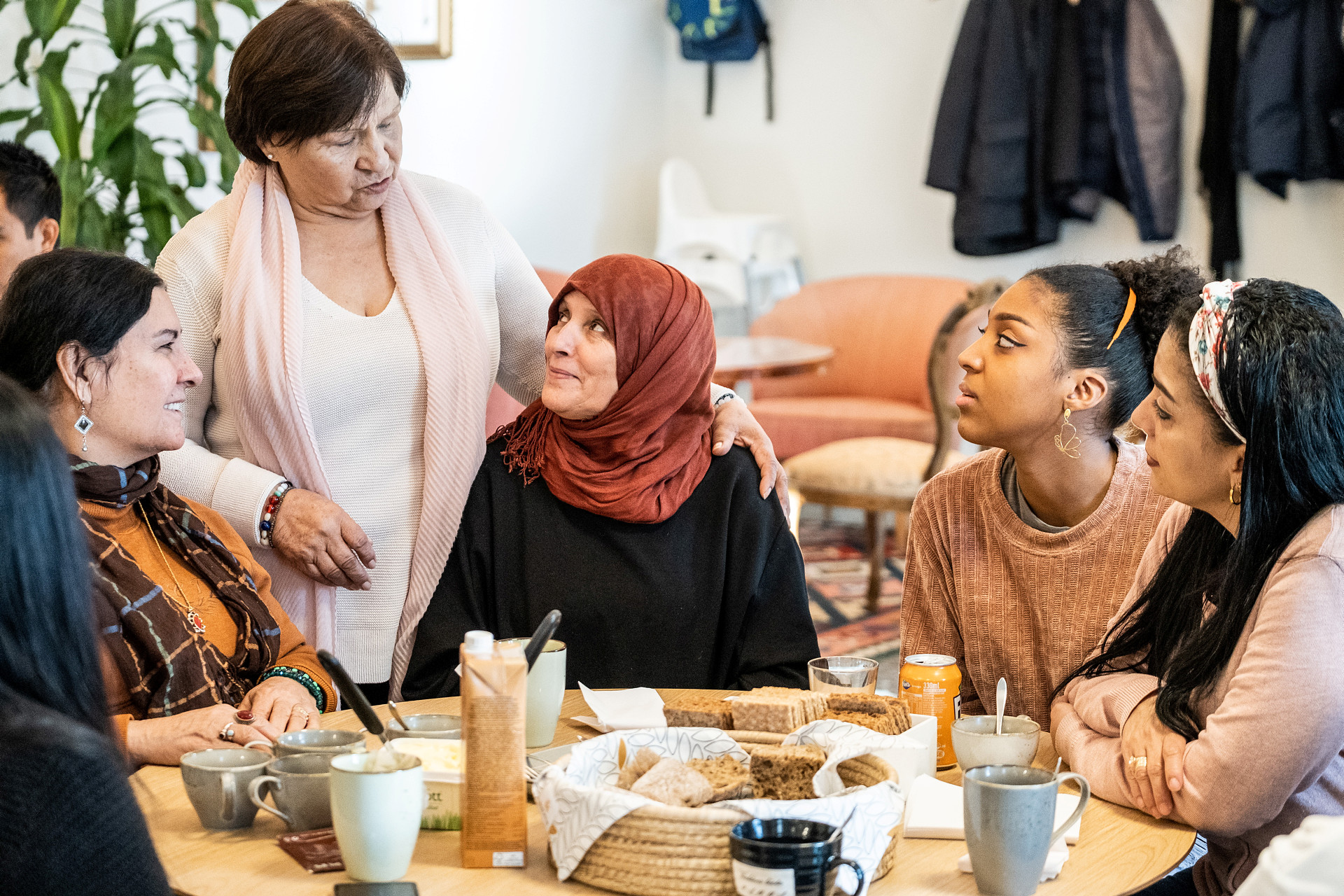 Women around a table talking.