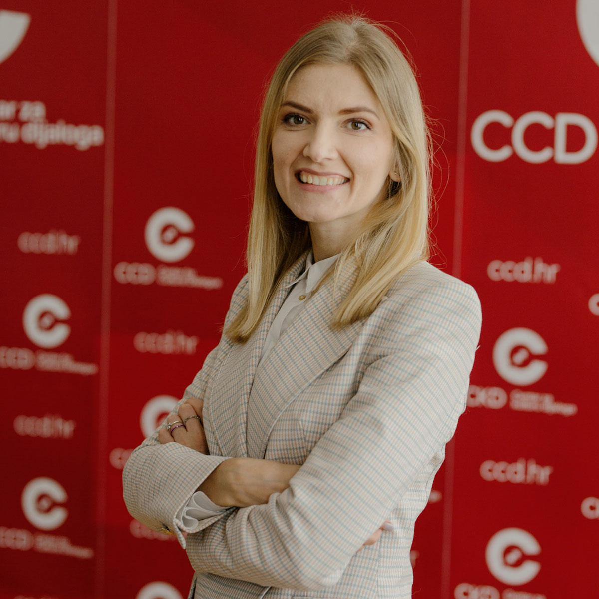 Portrait of woman in front of red wall.